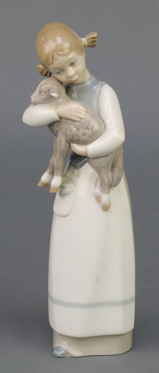 A Lladro figure of a young girl holding a lamb 8" 