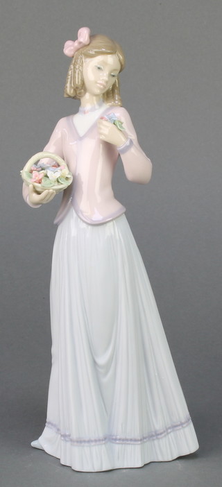 A Lladro Collectors Society figure Pretty and Prim 5554 9 1/2", boxed