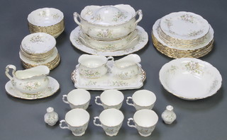 A Royal Albert Haworth pattern tea and dinner service comprising 6 tea cups, 6 saucers, sugar bowl, milk jug, sauceboat and stand, 2 rectangular dishes, salt and pepper, 8 small plates, 8 medium plates, 8 dinner plates, a tureen and lid, 2 bowls and 2 dishes 
