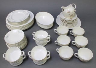 A Royal Worcester Dorset pattern dinner service comprising 6 two handled bowls, 6 saucers, 6 small plates, 6 medium plates, 7 dinner plates, a vegetable dish and bowl,  a Royal Doulton Tumbling Leaves part tea set with 6 tea cups, 6 saucers, 6 small plates, a serving plate, sugar bowl and milk jug