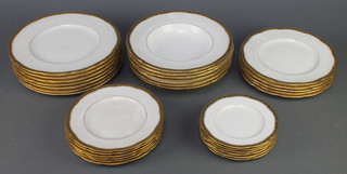 A Mintons part dinner service with gilt rims comprising 6 small side plates, 6 medium plates, 5 large plates, 7 dinner plates and 6 soup bowls 
