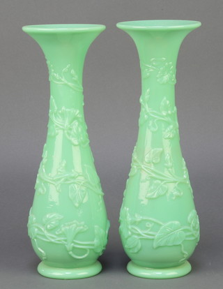 A pair of Chinese style moulded green glass vases decorated with scrolling flowers 13"  
