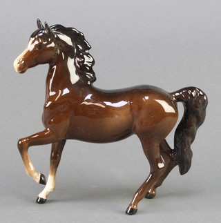 A Beswick figure of a standing pony, front leg raised, 7" 