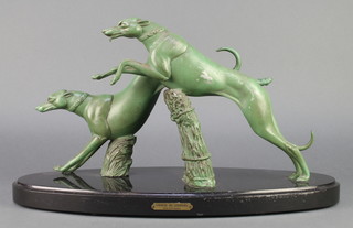 After Par Rochard, an Art Deco verdigris spelter figure group of 2 grey hounds leaping a wicket fence, raised on an oval black marble base 12"h x 21"w x 8"d  