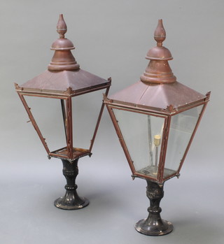 A pair of Victorian style copper and aluminium external lamp houses of waisted form, raised on aluminium bases 47"h x 17" square