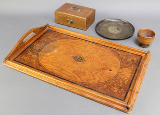 A circular bronze dish marked 3", an Art Nouveau oak inlaid twin handled tea tray 21" x 13" (damage by one of the handles), an oak box with hinged lid 3" x 7" x 5" and a turned wooden bowl 2 1/2" x 3" 
