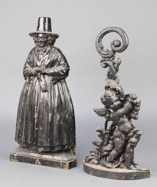 A Victorian cast iron door stop in the form of a cherub 16" and 1 other door stop in the form of a standing knitting Welsh lady 