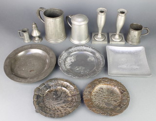 A large Victorian pewter tankard 6", 2 other pewter tankards, a pair of Art Nouveau style pewter candlesticks with detachable sconces raised on square feet 7", Continental pewter measure, a pewter baluster shaped pepper pot, circular pewter plate with London touch marks 9 1/2", 4 Continental antimony dishes and a thermometer 