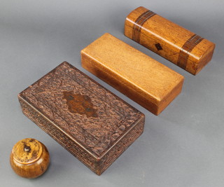 A carved Indian trinket box with hinged lid 2 1/2" x 10" x 6" (slight damage to carving) a rectangular oak card box with hinged lid 2 1/2" x 10" x 4", a rectangular inlaid mahogany dome shaped glove box with hinged lid and steel inlay 3" x 10" x 3" (some of the stringing is loose) and a turned treen box 3" 