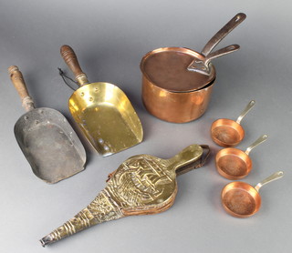 A 19th Century circular copper sauce pan with polished steel handle 7", some dents, 2 Victorian brass and copper coal shovels, 3 copper and brass brandy saucepans marked names of pubs, a circular aluminium coaster marked Gordon Russell International Championship Brands Hatch