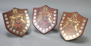 3 shield shaped trophies with armorial decoration 16" x 13" 