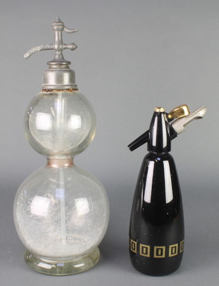 A glass double gourd shaped soda siphon 19" (missing mesh to outer body) and a BOAC soda siphon