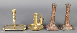 A brass candlestick raised on a rectangular tray base with bracket feet 5", a brass chamber stick and snuffer 4", a pair of Chinese antimony candlesticks decorated dragons 7" (sconces missing and damage to base) 
