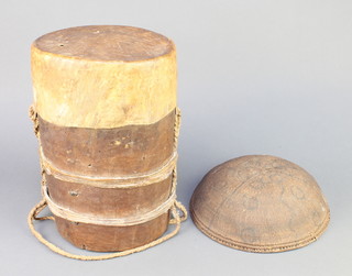 A cylindrical tribal drum 13"h x 8" diam. together with a circular African basket 10"