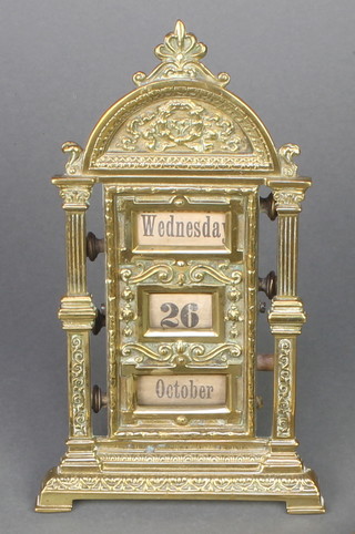 A Victorian brass perpetual calendar contained in an arch shaped case 8" 