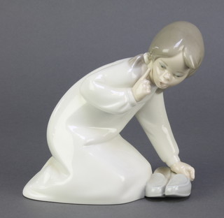 A Lladro figure of a kneeling girl with slippers 8" 