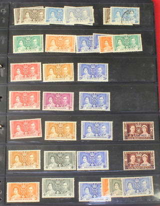 An album of mint and used 1935 Silver Jubilee stamps, Commonwealth Jubilee stamps together with 1937 Coronation stamps and 1945 Victory stamps 