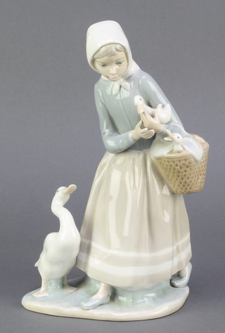 A Lladro figure of a girl with a basket and geese 9" 