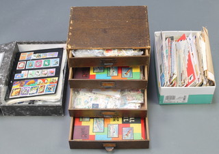 A table top 4 drawer filing chest containing a collection of loose World stamps, a ditto shoe box and a collection of first day covers and loose World stamps