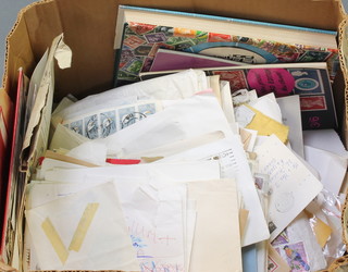 A box of loose stamps, stamped envelopes etc