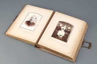 A Victorian leather bound family photograph album containing a quantity of portrait photographs 