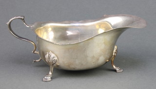 A silver sauce boat of plain form on pad feet, Chester 1936 104 grams 