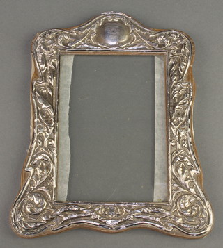 A repousse silver photograph frame with scroll and floral decoration Chester 1918 8" x 6" 
