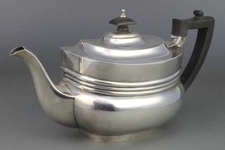 A rounded rectangular silver teapot with ebony mounts London 1926, gross 700 grams