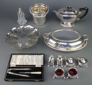 An oval silver plated entree dish and minor plated items 
