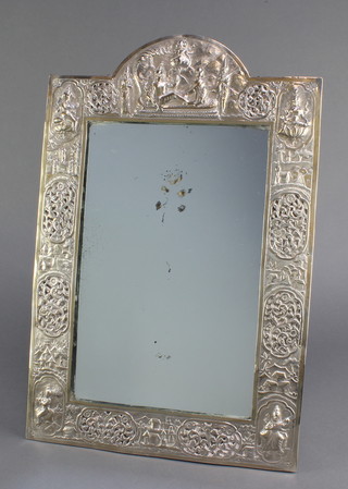 A good early 20th Century Indian silver easel mirror, the repousse decoration with figures of Ganesh, Lakshmi  and other deities with panels of flowers and landscape views 18" x 11 3/4" 