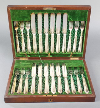A mahogany canteen containing a set of 12 silver plated fish eaters with chased blades 