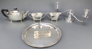 A silver plated 3 piece tea set, a 3 light candelabrum, pair of nips and a tray 