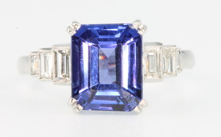 An 18ct white gold tanzanite and diamond ring, the centre stone approx. 3.25ct flanked by 3 baguette cut diamonds, size L 1/2
