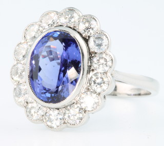 An 18ct white gold tanzanite and diamond cluster ring , the centre stone approx. 3.5 ct surrounded by brilliant cut diamonds, size N 1/2