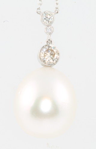 An 18ct white gold chain with a diamond and pearl set pendant 