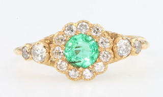 An 18ct yellow gold emerald and diamond cluster ring size N 1/2