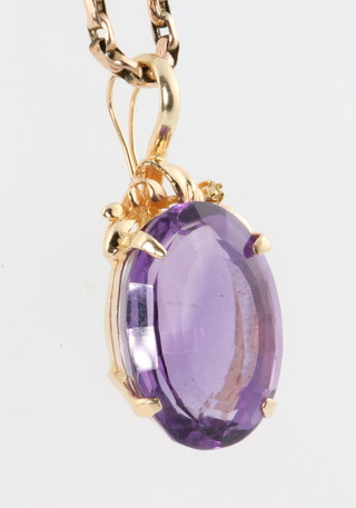 A 9ct yellow gold chain with a 14ct yellow gold amethyst set pendant