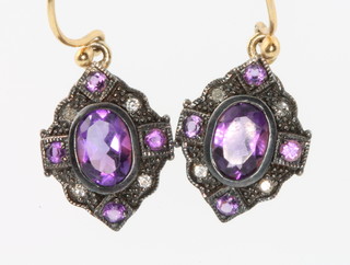A pair of Edwardian style yellow gold and amethyst earrings