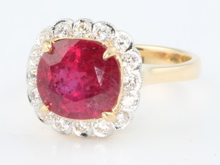 An 18ct yellow gold ruby and diamond cluster ring, the treated ruby approx. 3.78ct surrounded by brilliant cut diamonds 0.41ct, size N 