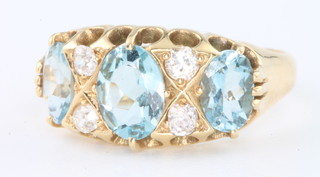 An 18ct yellow gold 3 stone aquamarine and diamond ring 
