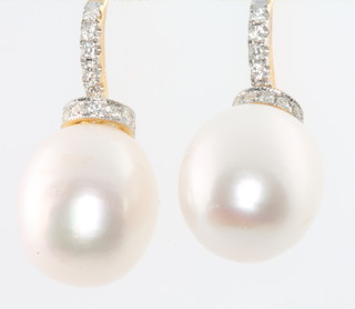 A pair of yellow gold diamond and pearl set earrings 