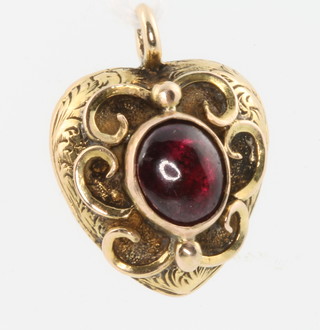 An Edwardian yellow gold cabochon cut garnet heart shaped pendant 