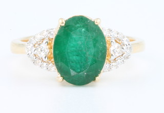 An 18ct yellow gold emerald and diamond ring size N 