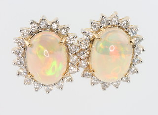 A pair of yellow gold opal and diamond ear studs 