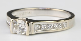 An 18ct white gold brilliant cut diamond ring with 6 diamonds to each shoulder size K 1/2 