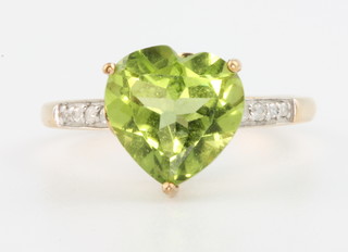 A 9ct yellow gold heart cut peridot and diamond ring, size N