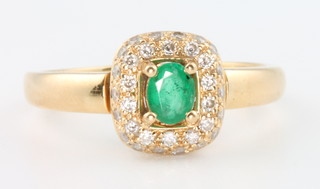 An 18ct yellow gold emerald and diamond ring size S