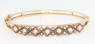An 18ct yellow gold guilloche enamel, seed pearl and diamond bangle 
