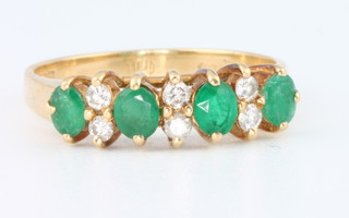 An 18ct yellow gold emerald and diamond ring size Q
