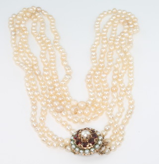A 3 row pearl necklace with 9ct yellow gold garnet set clasp 